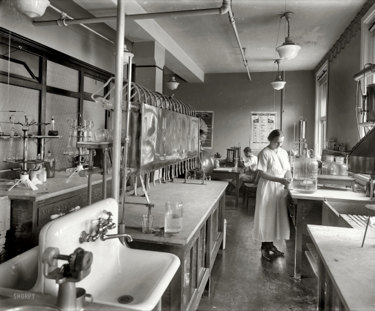 Photo showing: Bread Lab -- Washington, D.C., circa 1922. Mrs. M.M. Brooke, chemist in charge of the Corby Baking Co. laboratory.