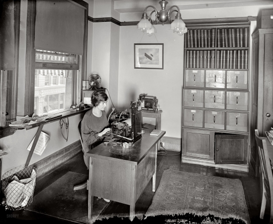 Photo showing: The Office: 1923 -- Washington, D.C., August 1923. National Highways Association. Note Dictaphone and the Ediphone cylinders. 