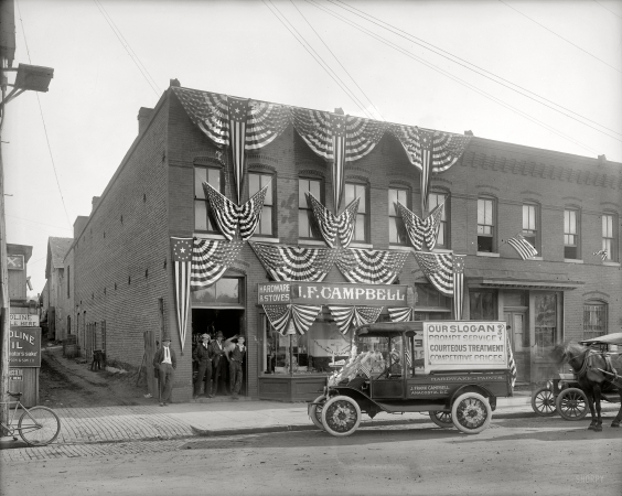 Photo showing: Anacostia Hardware -- Washington, D.C., circa 1918. J.F. Campbell, Anacostia, decorated with American flags.
