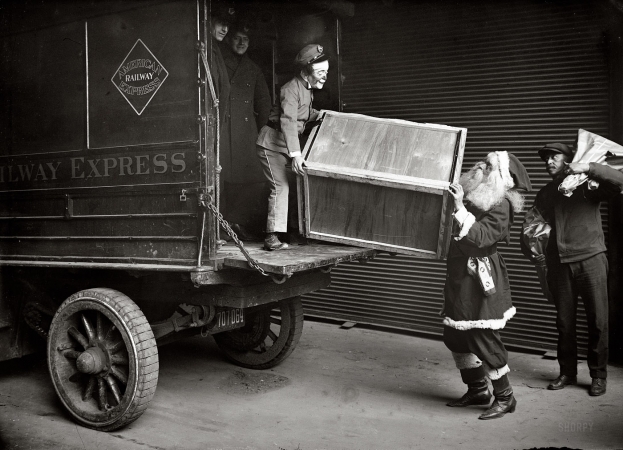 Photo showing: Scary Santa Helper -- New York, December 1924. Unloading Railway Express car.