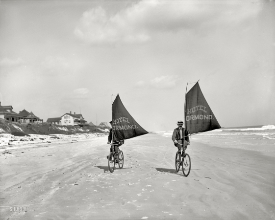 Photo showing: Wind Biking -- Volusia County, Florida, circa 1903. Sailing bicycles on the beach at Ormond.