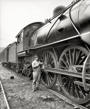 Photo showing: Locomotive Lube Job -- Michigan Central Railroad engineer oiling up before the start, circa 1904.
