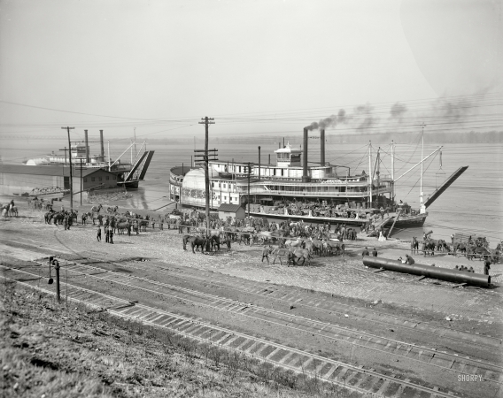 Photo showing: Life on the Mississippi -- On the Mississippi circa 1900. The levee at Memphis. Sidewheeler James Lee.