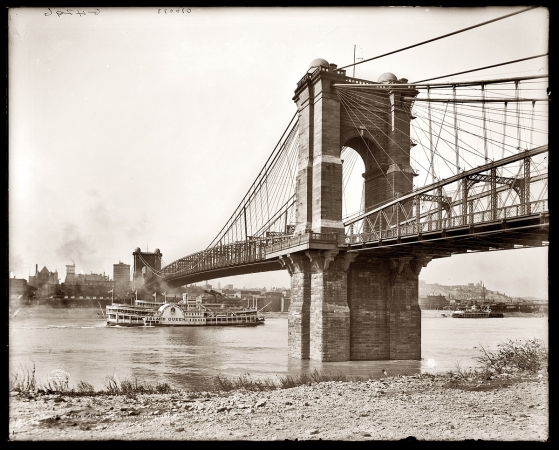 Photo showing: Roebling Suspension Bridge -- The Coney Island Co. side-wheeler Island Queen on the Ohio River between Covington, Kentucky, and Cincinnati in 1907.