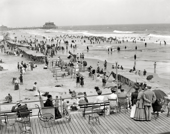 Photo showing: Regarding Jersey Shore -- Atlantic City circa 1908. A nattily-attired group enjoys a view of the bathing beach.