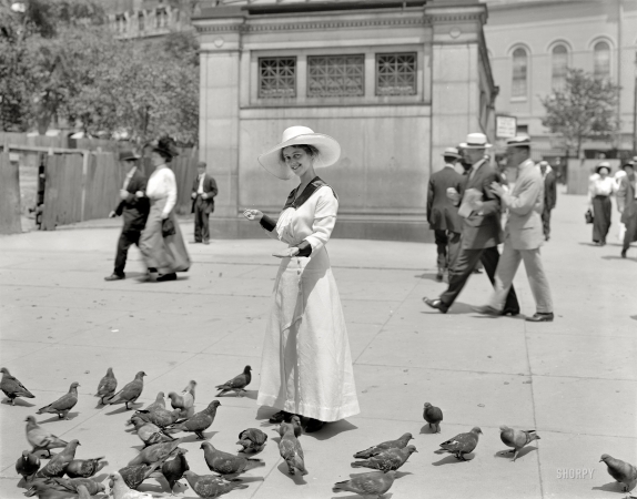 Photo showing: The Bird Feeder -- Boston, circa 1915. Feeding the pigeons in Boston Common.