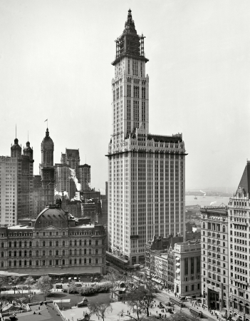 Photo showing: Woolworth Building Rising -- With City Hall Park, post office, the Singer and Park Row Buildings, New York circa 1912.