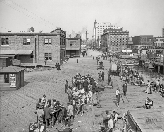 Photo showing: Lunch on the Levee -- The St. Johns River circa 1910. Lunch hour on the levee -- Jacksonville, Florida.