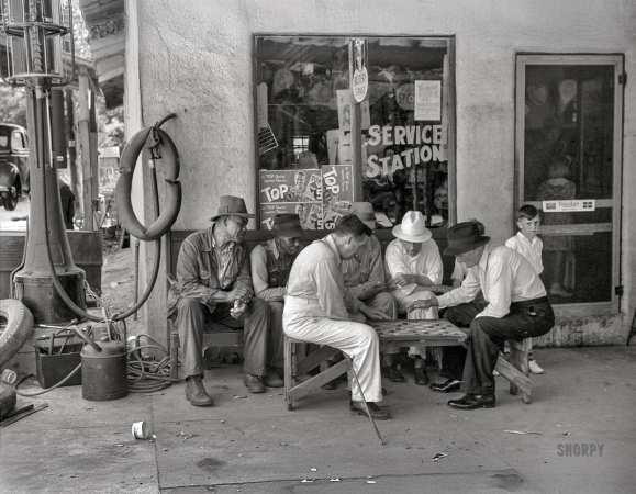 Photo showing: Your Move -- June 1939. Greensboro, Greene County, Georgia. Playing checkers outside a service station on a Saturday afternoon.