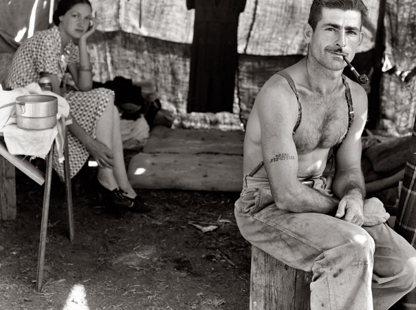 Photo showing: 535-07-5248 and Wife -- Oregon, August 1939. Unemployed lumber worker with his wife. Note Social Security number tattooed on his arm.