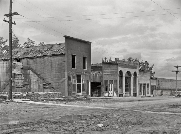 Photo showing: Retail Graveyard -- June 1939. Abandoned stores in ghost mining town. Pony, Montana.