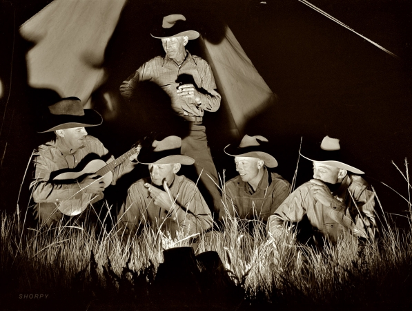 Photo showing: Montana Cowboys -- June 1939. Big Horn County, Montana. Quarter Circle U Ranch roundup. Cowhands singing after a day's work.