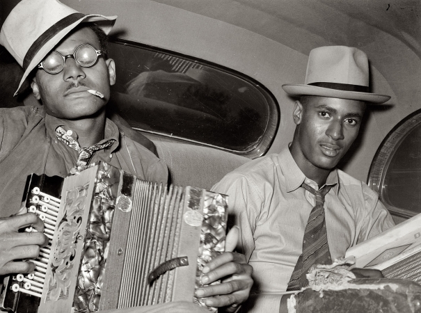 Photo showing: Back Seat Duet -- October 1938. Musicians playing accordion and washboard in automobile near New Iberia, Louisiana.