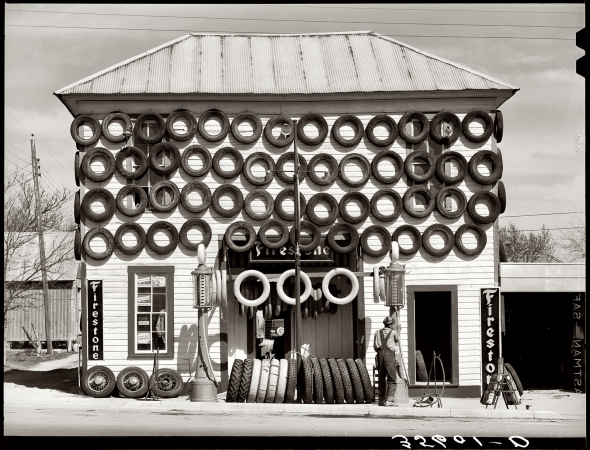 Photo showing: House of Tires -- March 1940. Secondhand tires for sale at a gas station in San Marcos, Texas.