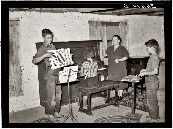 Photo showing: The Pie Town Trio -- June 1940. Pie Town, New Mexico. Wife of a homesteader with her WPA (Work Projects Administration) music class.