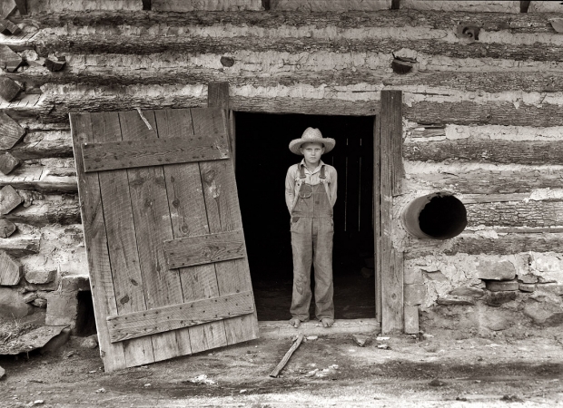 Photo showing: Farm Boy: 1939 -- Farm boy in the doorway of a tobacco barn, Person County, North Carolina.