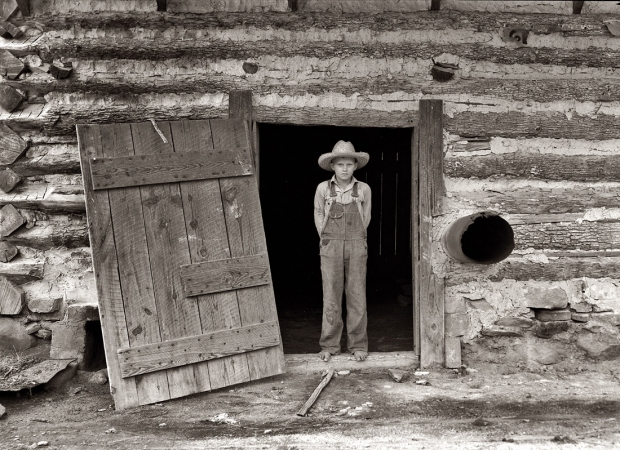 Photo showing: Farm Boy: 1939 -- Farm boy in the doorway of a tobacco barn, Person County, North Carolina.