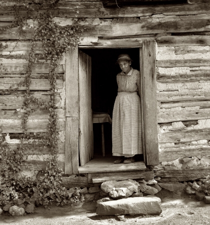Photo showing: Caroline -- Caroline Atwater standing in the kitchen door of her log house. Orange County, North Carolina, July 1939.