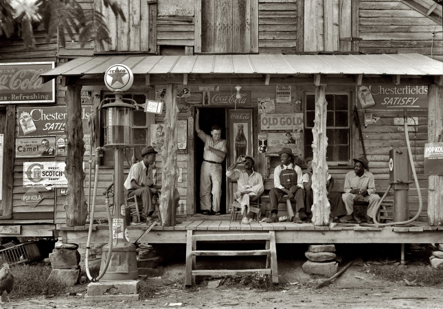 Photo showing: Cracker Barrel -- July 1939. Gordonton, N.C. Country store on dirt road. Sunday afternoon.