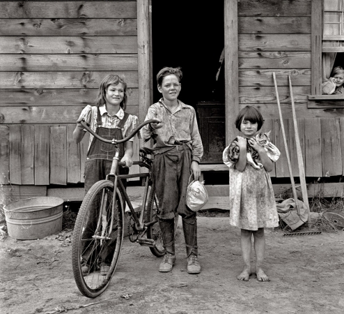 Photo showing: The Simple Life -- August 1939. Three of the four Arnold children outside their farmhouse
at Michigan Hill. Thurston County, western Washington.