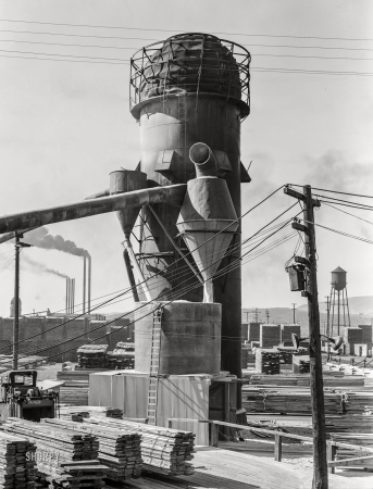 Photo showing: The Infernoing Tower -- September 1939. Klamath Falls, Oregon. Burner (to dispose of sawdust and waste)
and stacks of the Big Lakes Lumber Company, which produces shook for produce boxes.