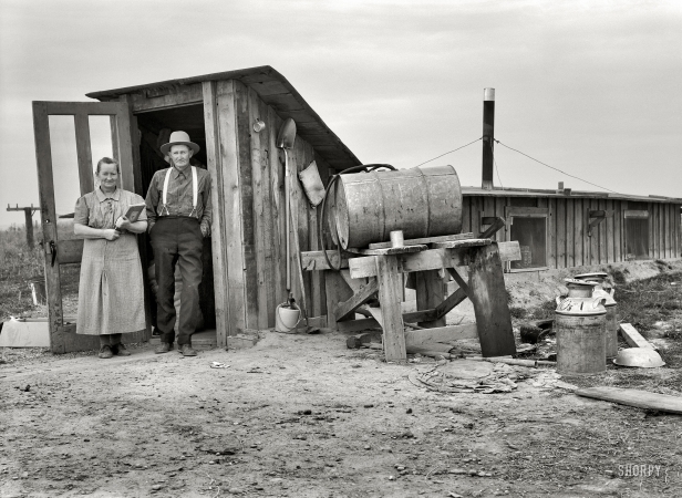 Photo showing: Come on Down -- Mr. and Mrs. Wardlaw at entrance to their dugout basement home. Dead Ox Flat, Malheur County, Oregon, October 1939.