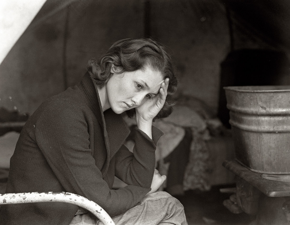 Photo showing: Migrant Daughter -- Daughter of migrant Tennessee coal miner, American River camp near Sacramento, California, 1936.