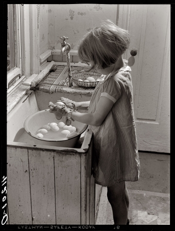 Photo showing: I Am the Egg Girl -- August 1940. Little girl at the Reitz farm near Falls Creek, Pa., washing eggs.