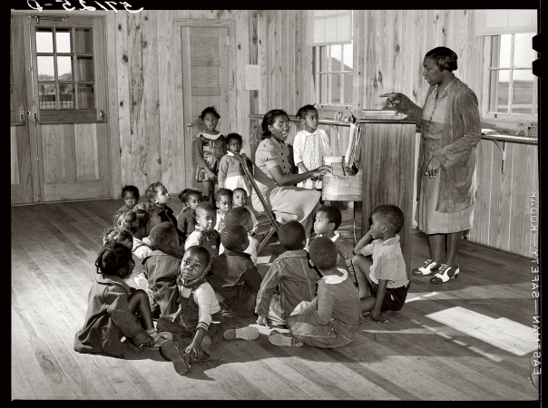 Photo showing: Okeechobee Sing-Along -- February 1941. Labor camp day nursery for migratory workers' children at Belle Glade, Florida.
