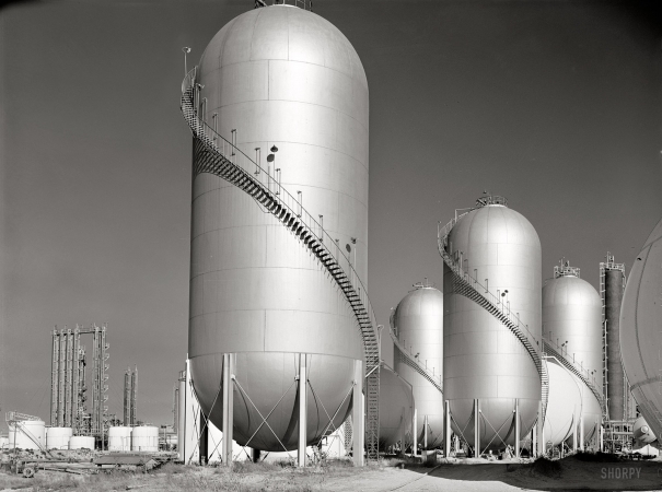 Photo showing: Gleaming Tanks -- Phillips gasoline plant storage tanks, Borger, Texas, November 1942.