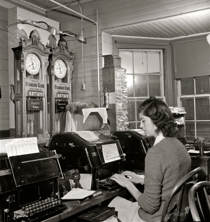 Photo showing: Railroad Telegraphy -- March 1943. Seligman, Arizona. Teletype operator in the telegraph office of the Atchison, Topeka, and Santa Fe Railroad.