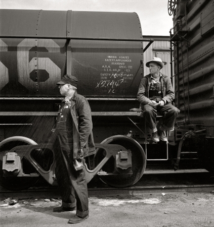 Photo showing: Brakemen -- March 1943. Barstow, California. Brakemen waiting for their train to pull out of the Atchison, Topeka and Santa Fe yard.