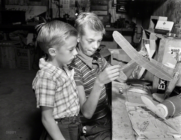 Photo showing: Wingman. -- Sept. 1942. Rochester, N.Y. Earl and Howard Babcock looking over one of the model airplanes which Howard built.