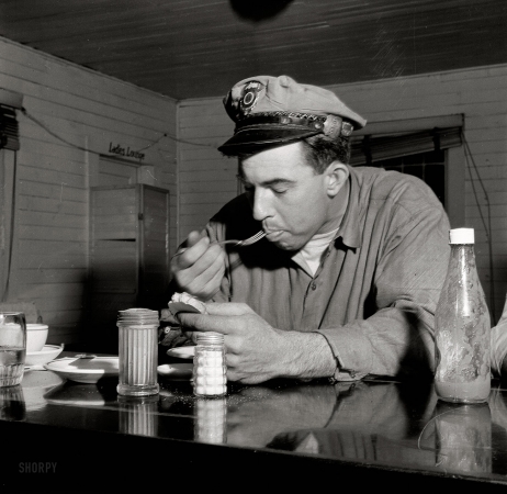 Photo showing: Truck Stop Diner -- March 1943. Pearlington, Mississippi (vicinity). Truck driver eating at a trucker's stop along U.S. Highway 90.