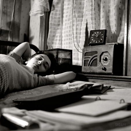 Photo showing: In My Room -- January 1943. Washington, D.C., war worker. A radio is company for this girl in her boardinghouse room.