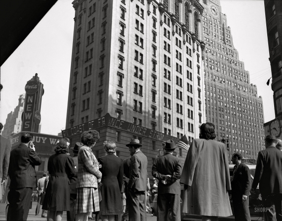Photo showing: New York on D-Day -- June 6, 1944. Crowd watching the news line on the Times building at Times Square.