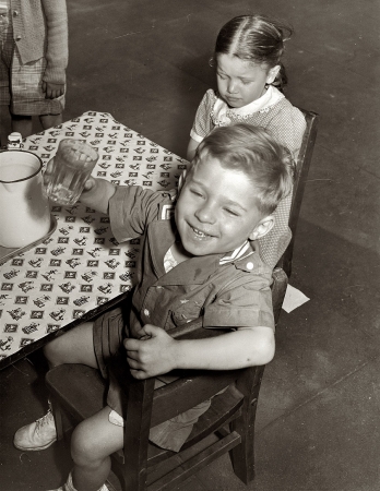 Photo showing: Pour Me Another: 1942 -- Children get milk or tomato juice after their nap at the nursery school at Queensbridge housing project.  Queens, N.Y.