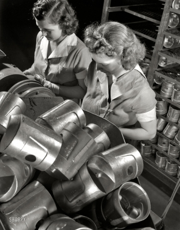 Photo showing: Head Spotters -- The heads of these pistons must be spotted prior to hardness testing at Aluminum Industries Inc., Cincinnati 1942.