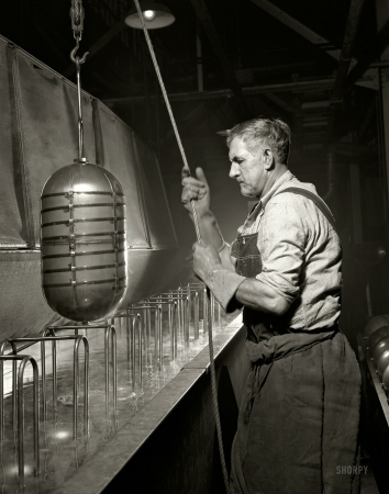 Photo showing: Essential War Work: 1942 -- Akron, Ohio. Bathing an aviation oxygen cylinder at a rubber factory now producing metal essential for the Army.