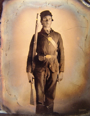 Photo showing: Ready for Duty -- 1861-65. Soldier in Union uniform and cap box standing with musket and bayonet with scabbard.