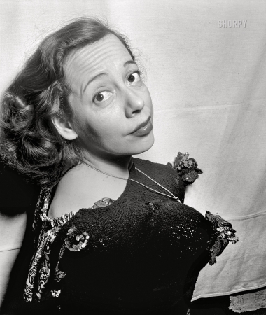 Photo showing: Coca-Nuts -- May 1947. New York -- Imogene Coca challenges Jane Russell and Betty George
to do as well, though she admits these are phonies made out of coconuts. 