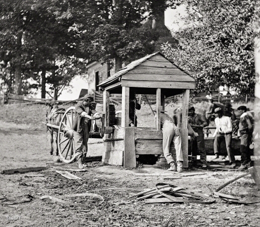 Photo showing: Watering-Hole -- 1864. Fredericksburg, Va. Army of the Potomac soldiers drawing from a well, filling their water cart.