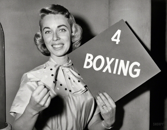 Photo showing: For the Win -- Nov. 15, 1955. Dr. Joyce Brothers holds up her category, boxing,
after winning $8,000 on the CBS television program The $64,000 Question.