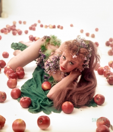 Photo showing: Red Delicious. -- May 1953. Entertainer Gwen Verdon dressed in a costume as Eve and surrounded by apples.