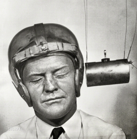 Photo showing: A Pounding Headache -- September 13, 1950. Pendulum pounding into a plastic helmet worn for testing ... 