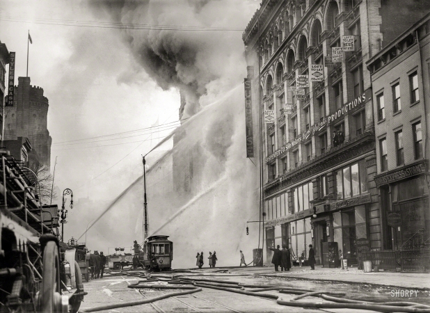 Photo showing: Surprise Fire -- December 20, 1909. Firemen spraying burning building on West 14th Street.
