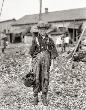 Photo showing: Raggedy Henry -- February 1912. Henry, 10-year-old oyster shucker who does five pots</br />
of oysters a day. Maggioni Canning Co., Port Royal, South Carolina.