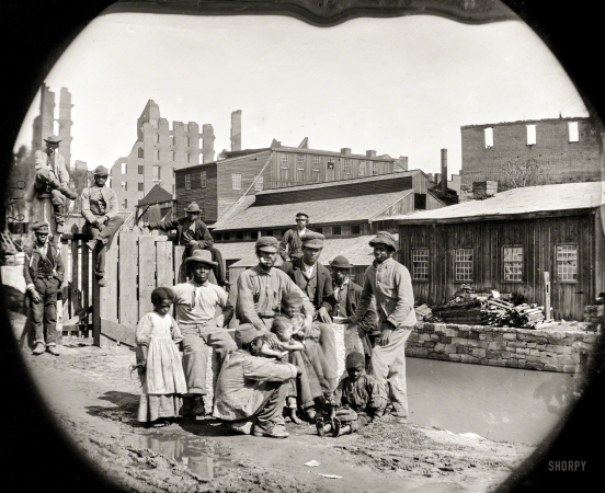 Photo showing: Free at Last -- June 9, 1865. Negro freedmen by canal -- group of Contrabands at Haxall's Mill, Richmond.