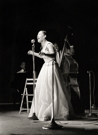 Photo showing: Lady Day -- Billie Holiday, with Teddy Wilson at the piano and Milt Hinton on bass, at the Newport Jazz Festival in 1954.