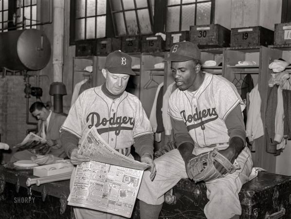 Photo showing: Baseball News -- September 1952. Brooklyn Dodgers manager Charley Dressen the locker room with Jackie Robinson.